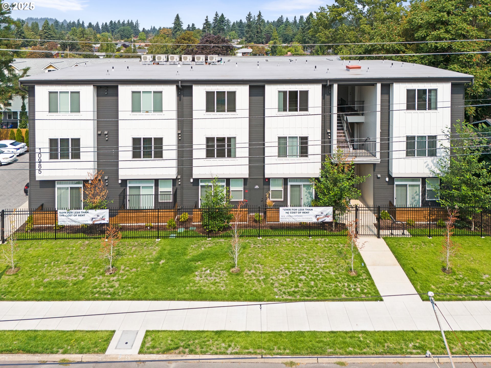 a front view of a residential apartment building with a yard