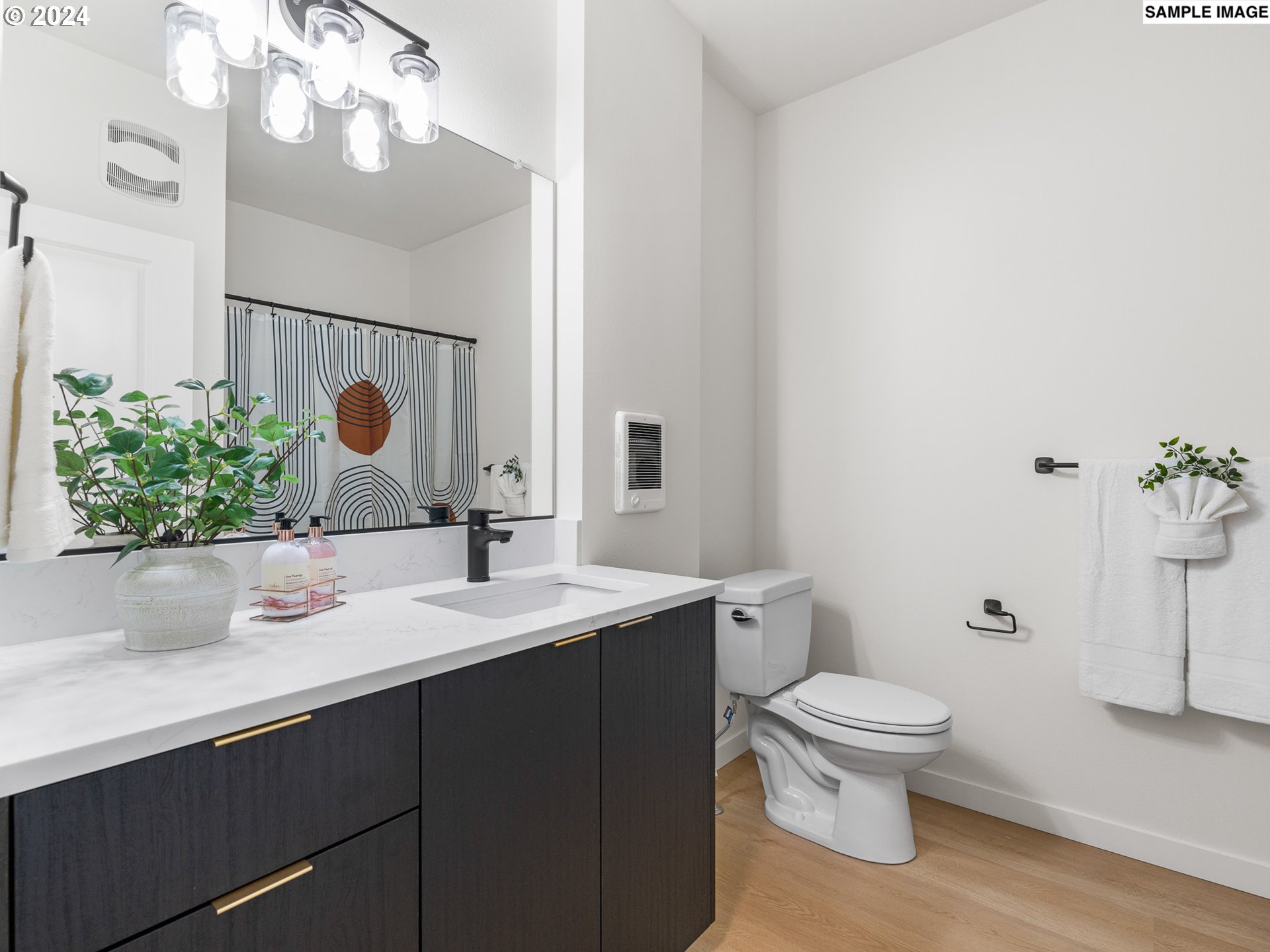 10985 East Burnside Street, Unit 24 Portland, OR 97216 - Photo 7 of 9 a bathroom with a toilet sink and mirror