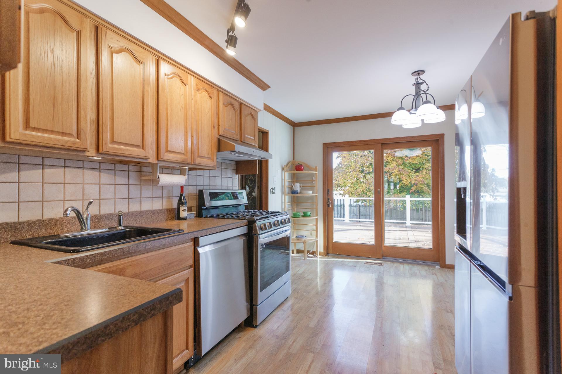 514 Drexel Road Fairless Hills, PA 19030 - Photo 13 of 31 a kitchen with stainless steel appliances granite countertop a stove a sink and a refrigerator