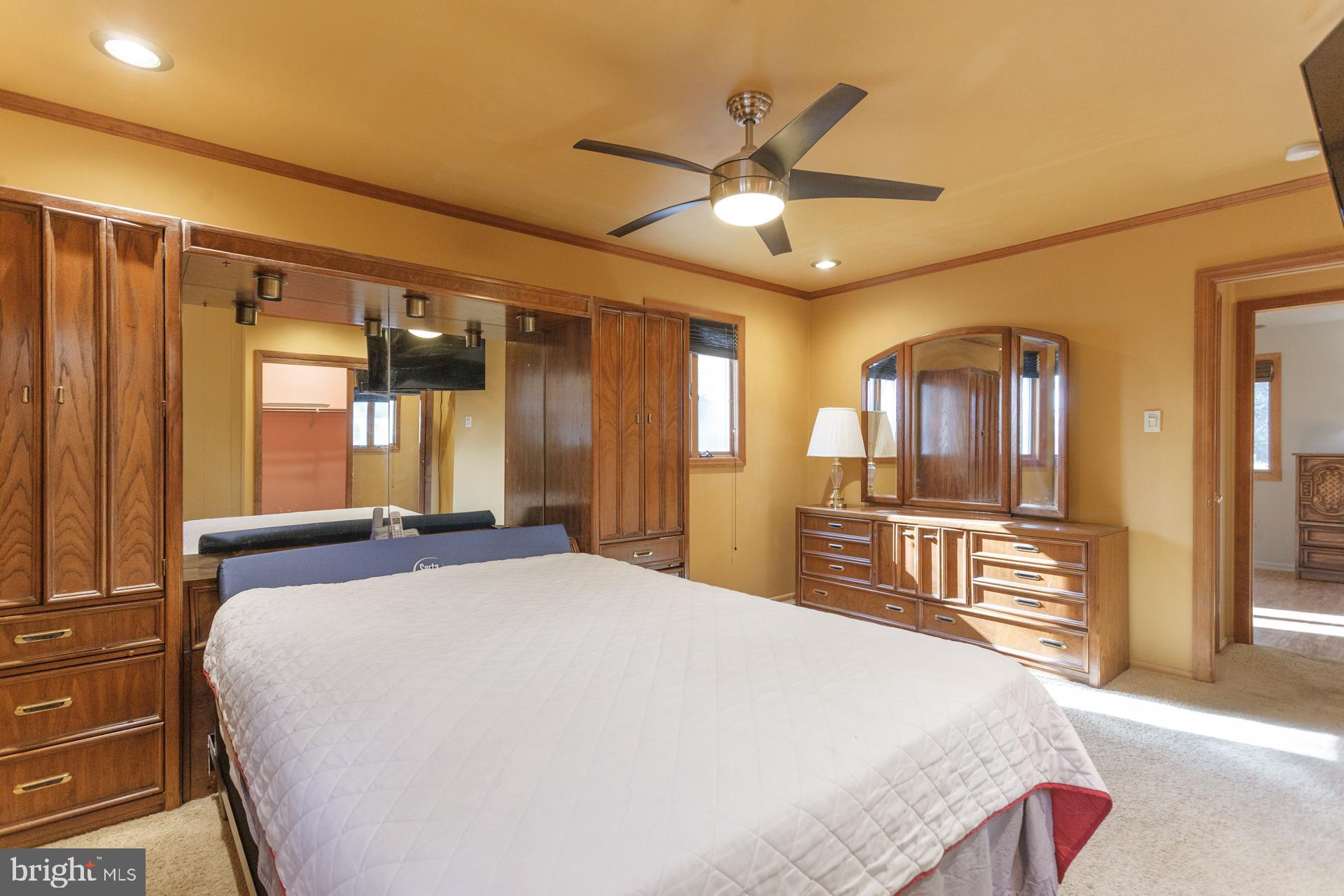 514 Drexel Road Fairless Hills, PA 19030 - Photo 21 of 31 a spacious bedroom with a large bed and a chandelier