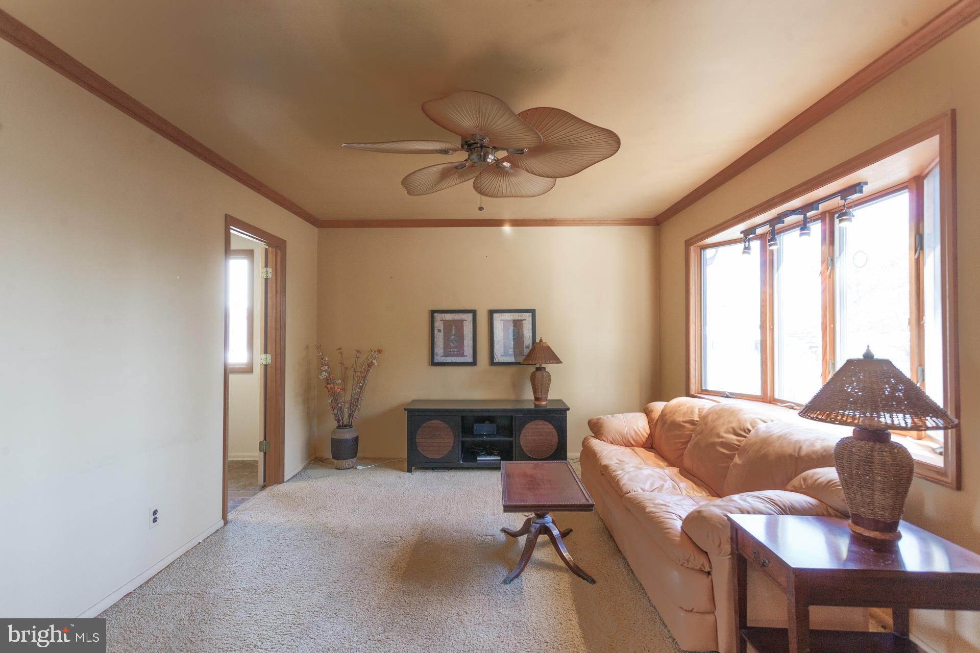 514 Drexel Road Fairless Hills, PA 19030 - Photo 8 of 31 a living room with furniture a fireplace and a large window