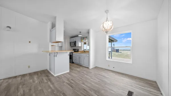 a view of a kitchen cabinets and wooden floor