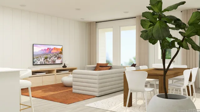 a living room with furniture flowerpot and a potted plant