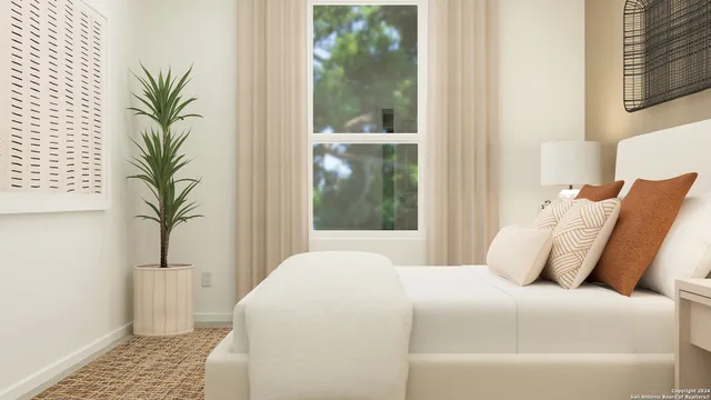 a bedroom with a large bed and a potted plant