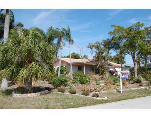 201 Northeast 26th Street Boca Raton, FL 33431 - Photo 1 of 18 a front view of a house with a yard