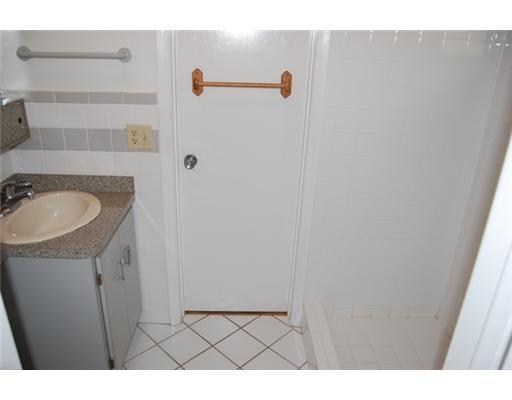 201 Northeast 26th Street Boca Raton, FL 33431 - Photo 14 of 18 a bathroom with a sink and a mirror