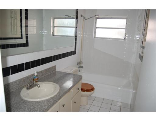 201 Northeast 26th Street Boca Raton, FL 33431 - Photo 18 of 18 a bathroom with a sink and a mirror