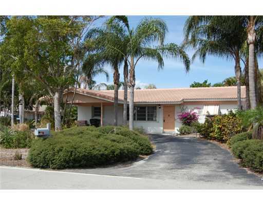 201 Northeast 26th Street Boca Raton, FL 33431 - Photo 2 of 18 a front view of a house with a garden