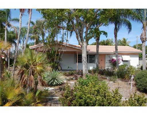201 Northeast 26th Street Boca Raton, FL 33431 - Photo 3 of 18 a front view of a house with garden