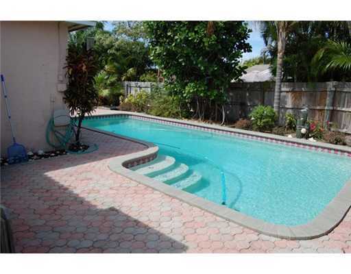 201 Northeast 26th Street Boca Raton, FL 33431 - Photo 4 of 18 a view of a backyard with swimming pool