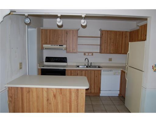 201 Northeast 26th Street Boca Raton, FL 33431 - Photo 9 of 18 a kitchen with a sink and a refrigerator
