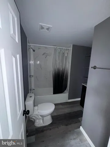 a bathroom with a toilet and a shower