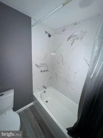 a bathroom with a bathtub and toilet