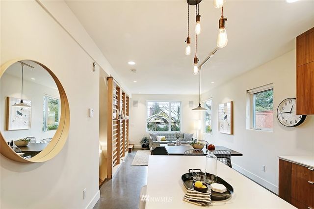 a living room with furniture and a mirror