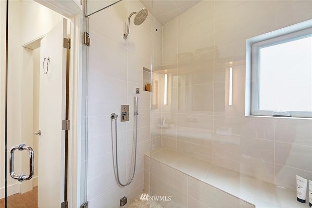 a bathroom with a glass shower door