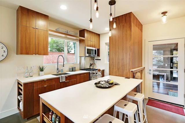 a kitchen that has a table chairs and a refrigerator