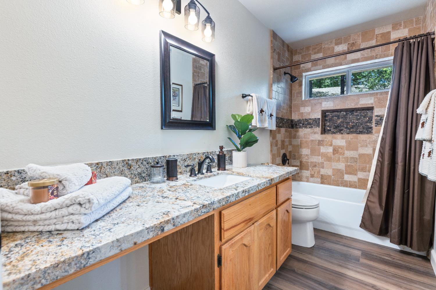 39398 Robin Bass Lake, CA 93604 - Photo 16 of 31 a bathroom with a granite countertop sink a toilet and a mirror