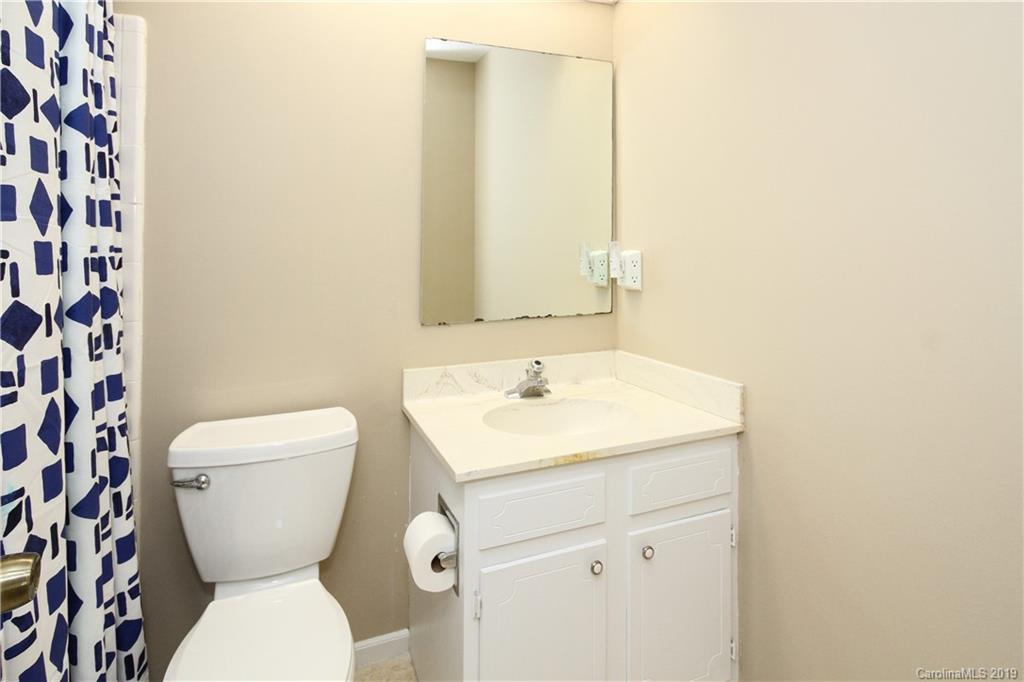 7825 Renaissance Court, Unit B Charlotte, NC 28226 - Photo 12 of 21 a bathroom with a toilet sink and mirror
