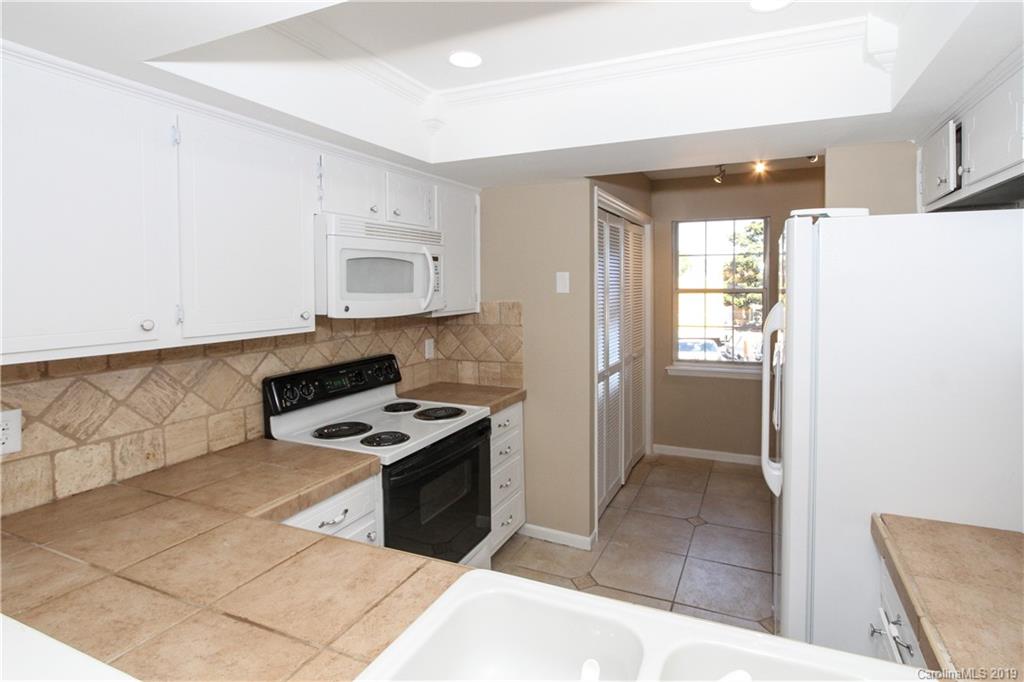 7825 Renaissance Court, Unit B Charlotte, NC 28226 - Photo 16 of 21 a kitchen with stainless steel appliances granite countertop a refrigerator and a stove