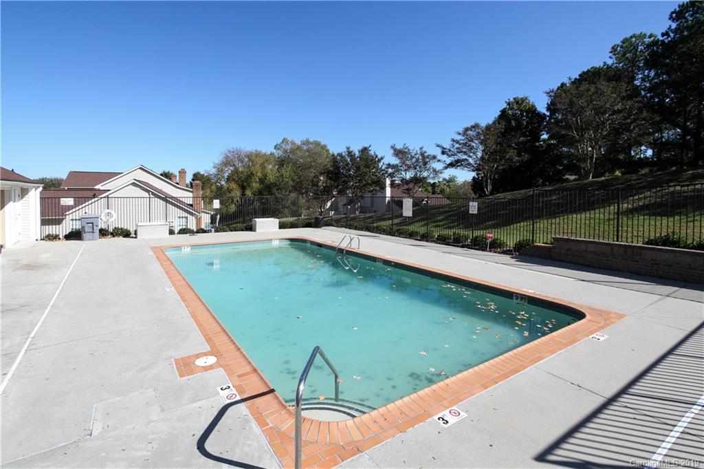 7825 Renaissance Court, Unit B Charlotte, NC 28226 - Photo 20 of 21 a view of a swimming pool with a yard