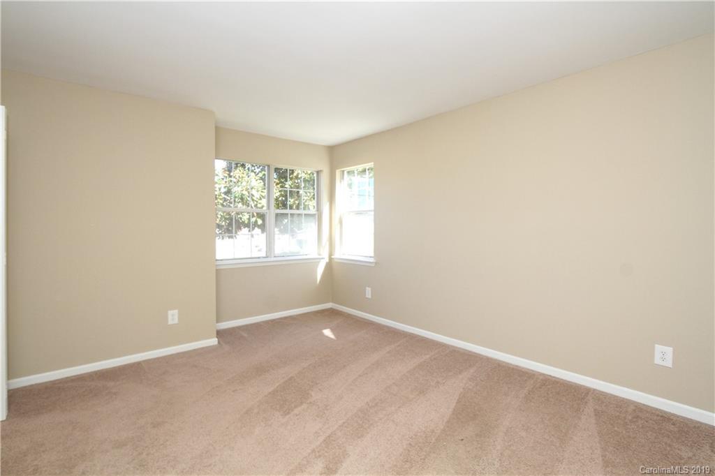 7825 Renaissance Court, Unit B Charlotte, NC 28226 - Photo 9 of 21 an empty room with windows