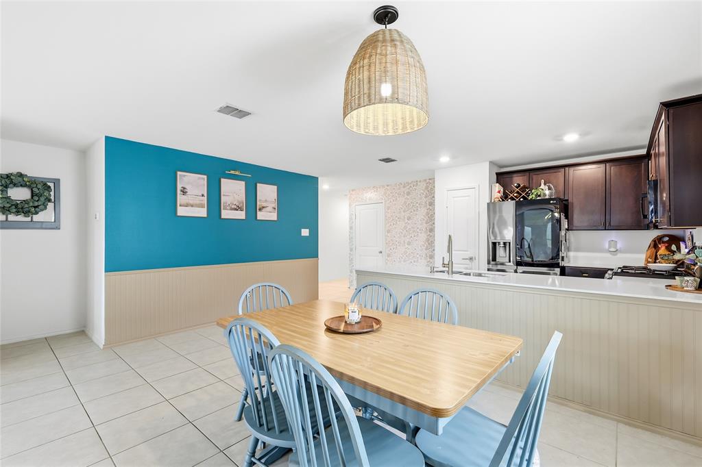 312 Ranchito Pass Fort Worth, TX 76052 - Photo 18 of 30 Dining area with a wainscoted wall and light tile patterned floors