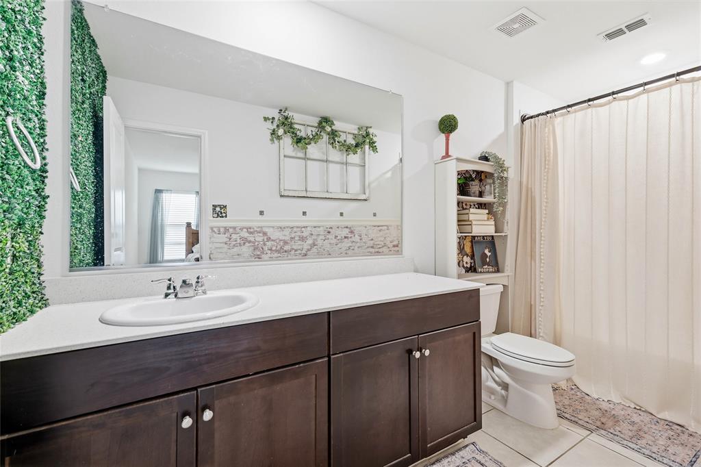 312 Ranchito Pass Fort Worth, TX 76052 - Photo 22 of 30 Bathroom with vanity, a shower with curtain, and light tile patterned floors