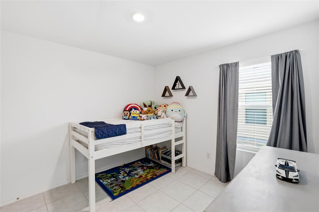 312 Ranchito Pass Fort Worth, TX 76052 - Photo 24 of 30 Bedroom featuring light tile patterned flooring and baseboards
