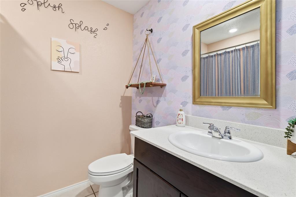 312 Ranchito Pass Fort Worth, TX 76052 - Photo 25 of 30 Full bath with vanity, curtained shower, wallpapered walls, and light tile patterned flooring