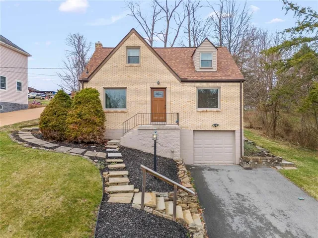 a front view of a house with a yard