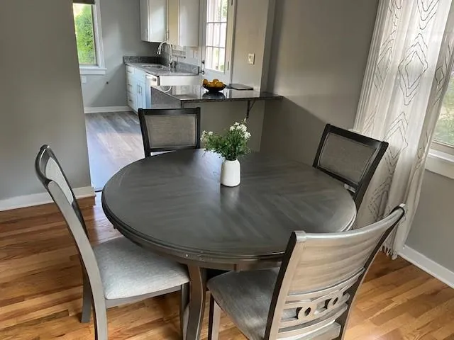 a view of a dining room with furniture and window