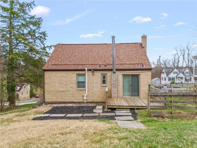a view of a balcony with wooden floor and fence