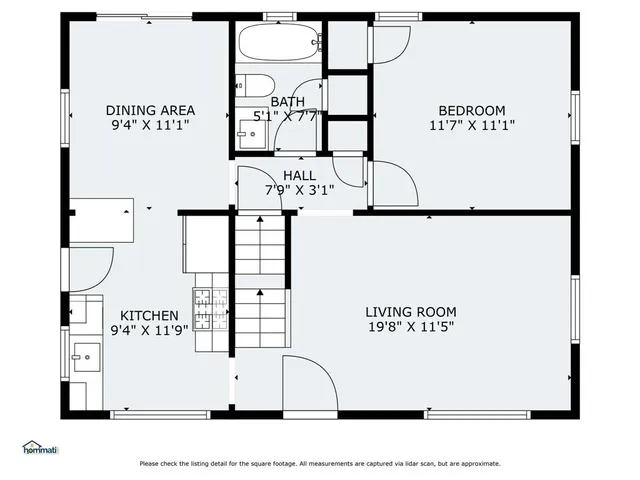 a living room with wooden floor and large window