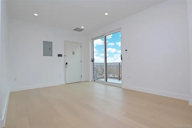 an empty room with kitchen view
