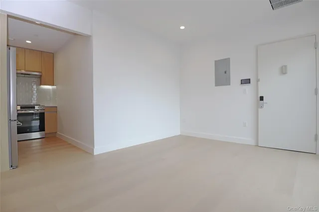 a view of an empty room with a sliding door