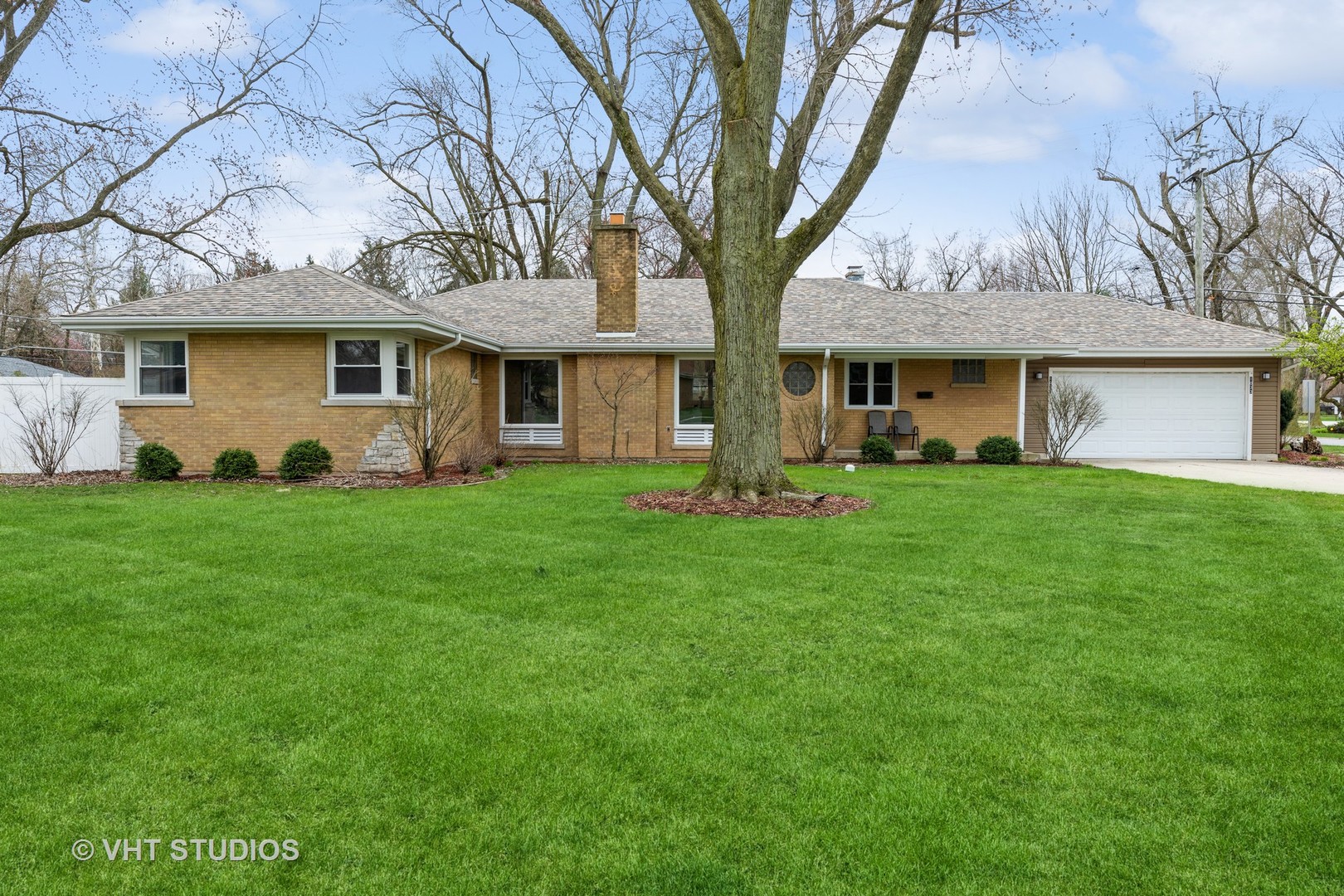 1033 Braemar Road Flossmoor, IL 60422 - Photo 1 of 15 a front view of a house with a garden and trees