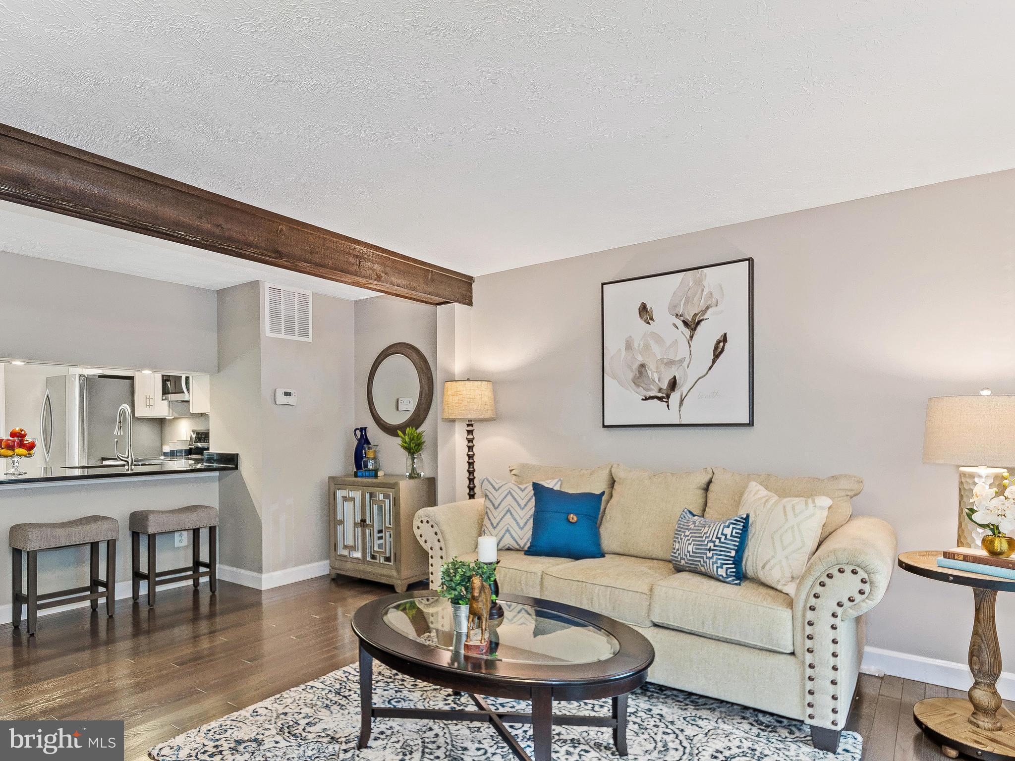 1931 Sagewood Lane Reston, VA 20191 - Photo 4 of 30 a living room with furniture a rug and wall paintings