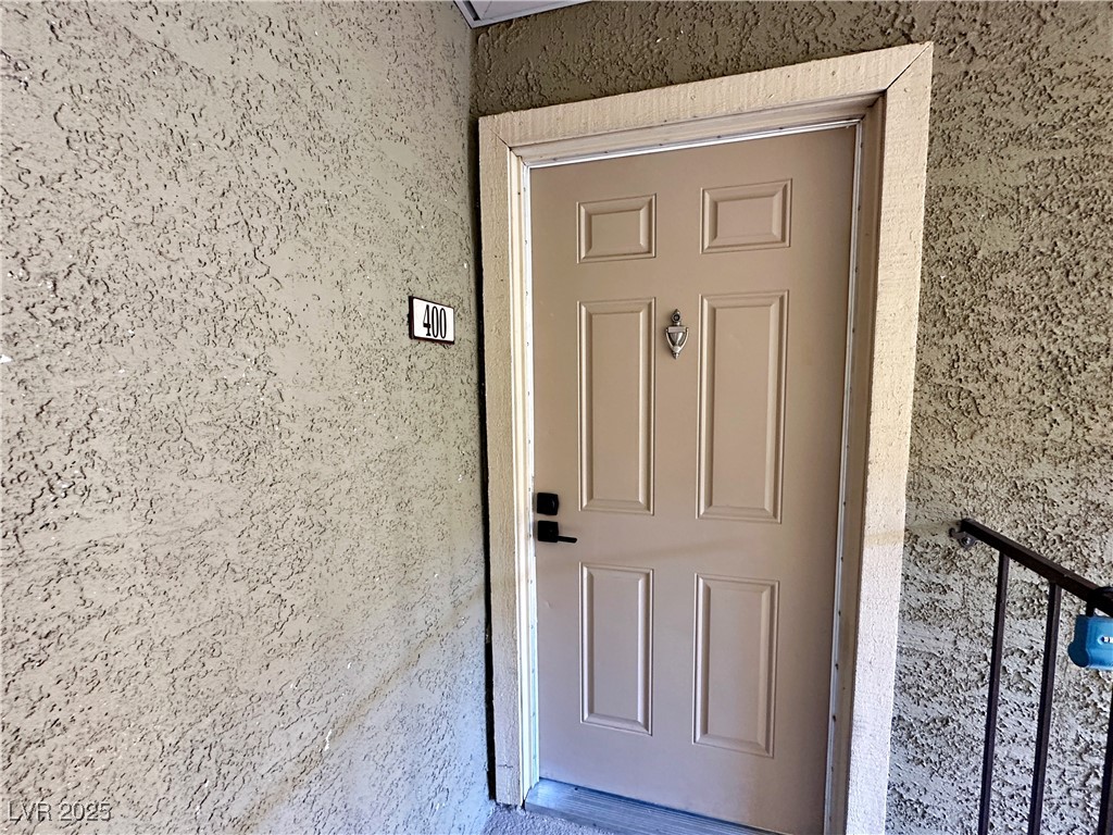 5080 Indian River Drive, Unit 400 Las Vegas, NV 89103 - Photo 2 of 29 View of exterior entry with stucco siding