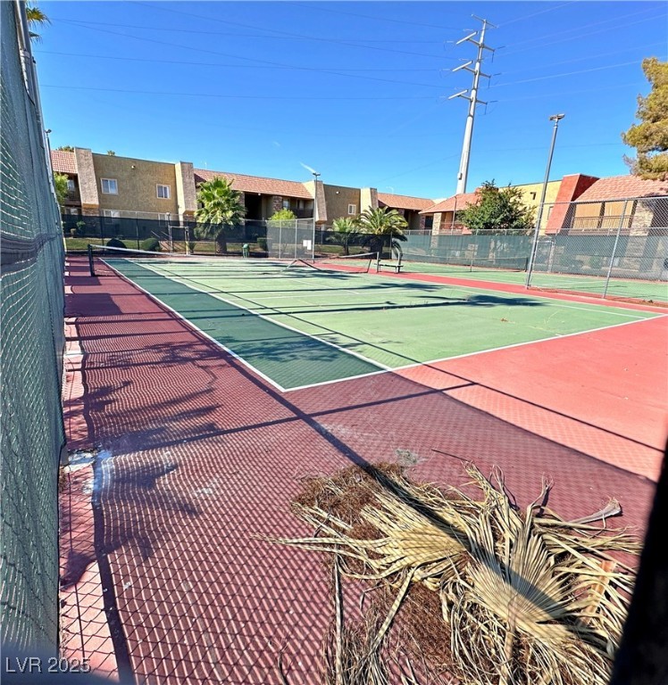 5080 Indian River Drive, Unit 400 Las Vegas, NV 89103 - Photo 28 of 29 View of tennis court featuring a residential view and community basketball court