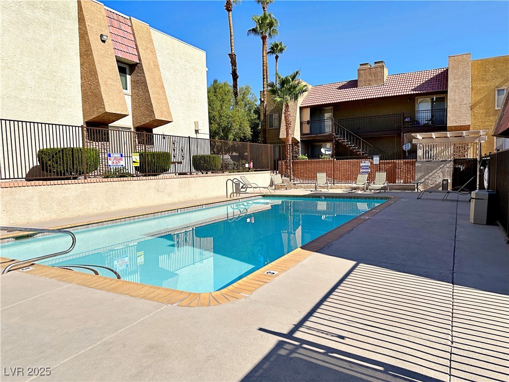 5080 Indian River Drive, Unit 400 Las Vegas, NV 89103 - Photo 29 of 29 Community pool featuring a patio area and a balcony