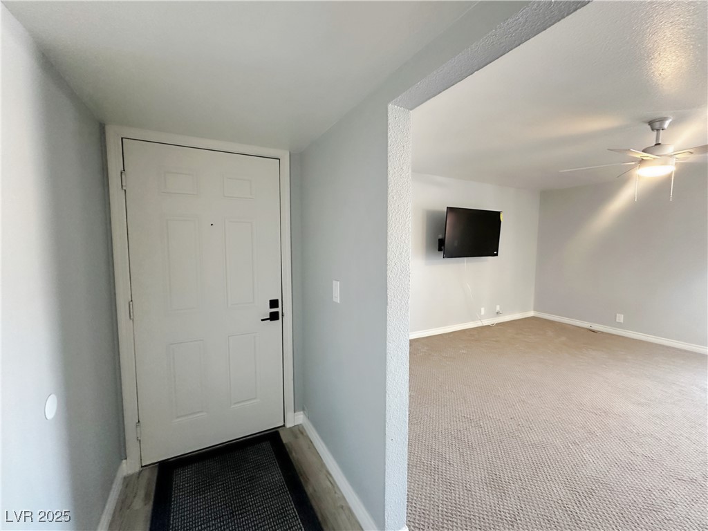 5080 Indian River Drive, Unit 400 Las Vegas, NV 89103 - Photo 3 of 29 Doorway to outside featuring baseboards and a ceiling fan