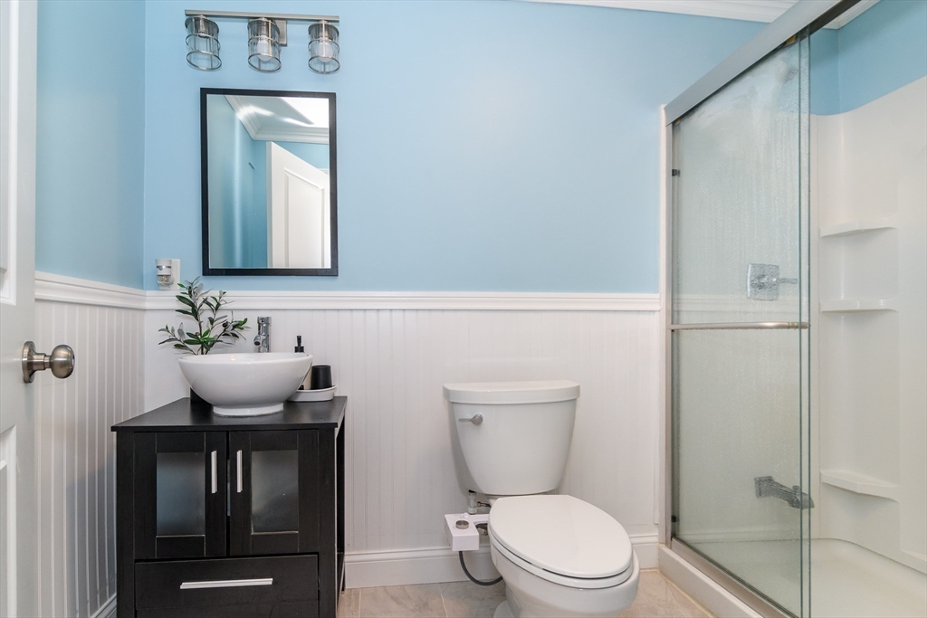 2 Hunters Lane Natick, MA 01760 - Photo 31 of 40 a bathroom with a toilet a sink and mirror