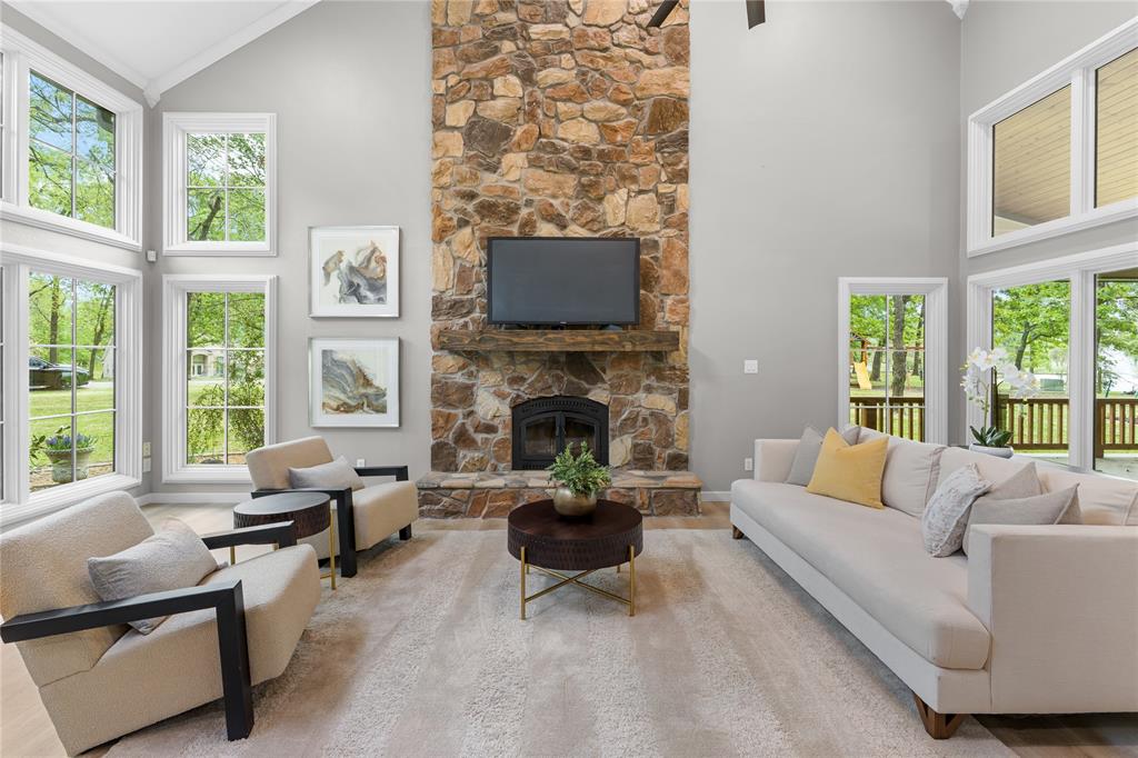 692 Private Road 5937 Emory, TX 75440 - Photo 11 of 40 a living room with furniture a fireplace and floor to ceiling windows