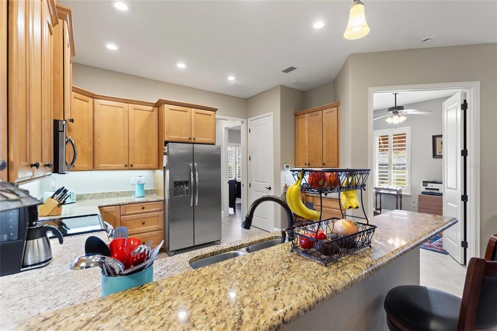 130 Laynewade Road Polk City, FL 33868 - Photo 12 of 41 a kitchen with stainless steel appliances granite countertop sink refrigerator and window