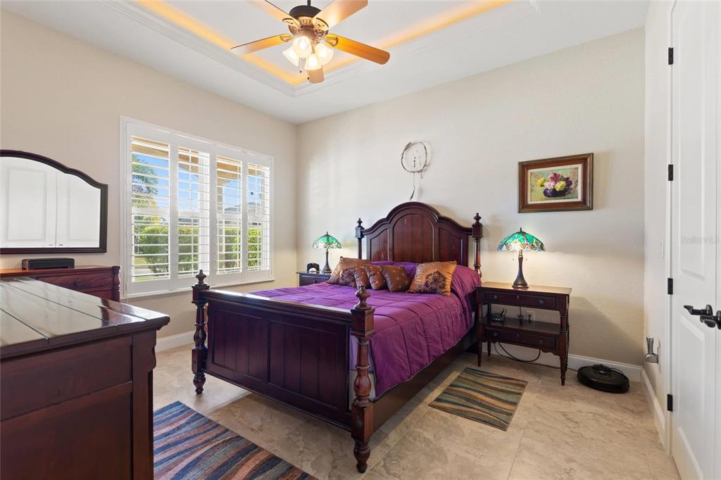 130 Laynewade Road Polk City, FL 33868 - Photo 14 of 41 a bedroom with a bed and a chandelier