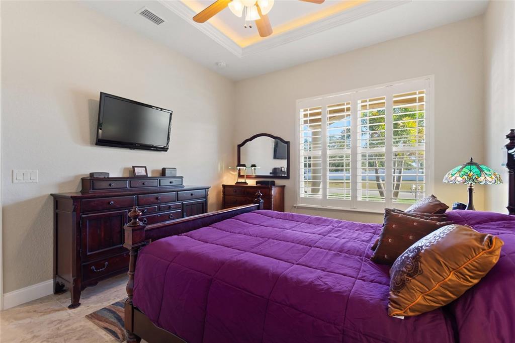 130 Laynewade Road Polk City, FL 33868 - Photo 15 of 41 a bedroom with a bed and a flat screen tv