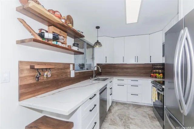 a kitchen with a sink a stove and cabinets