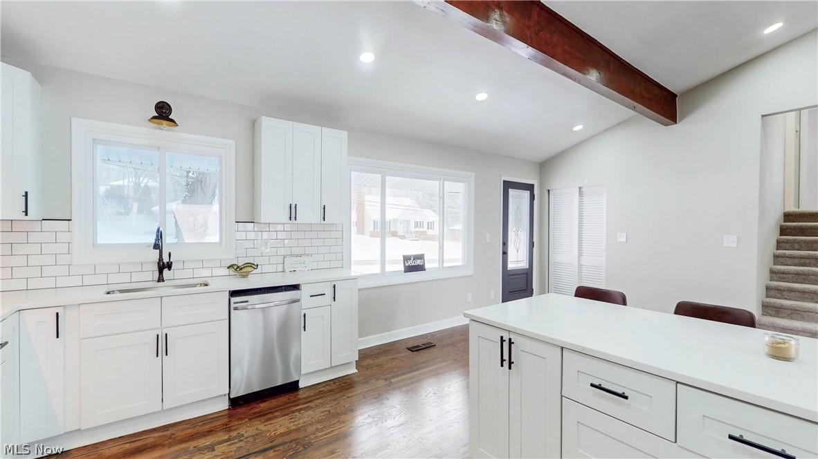 3312 Bancroft Road Akron, OH 44333 - Photo 6 of 50 Kitchen featuring lofted ceiling with beams, white cabinets, recessed lighting, dishwasher, and tasteful backsplash