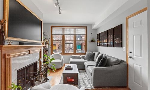 2033 West Huron Street, Unit 1 Chicago, IL 60612 - Photo 2 of 8 a living room with furniture and a flat screen tv
