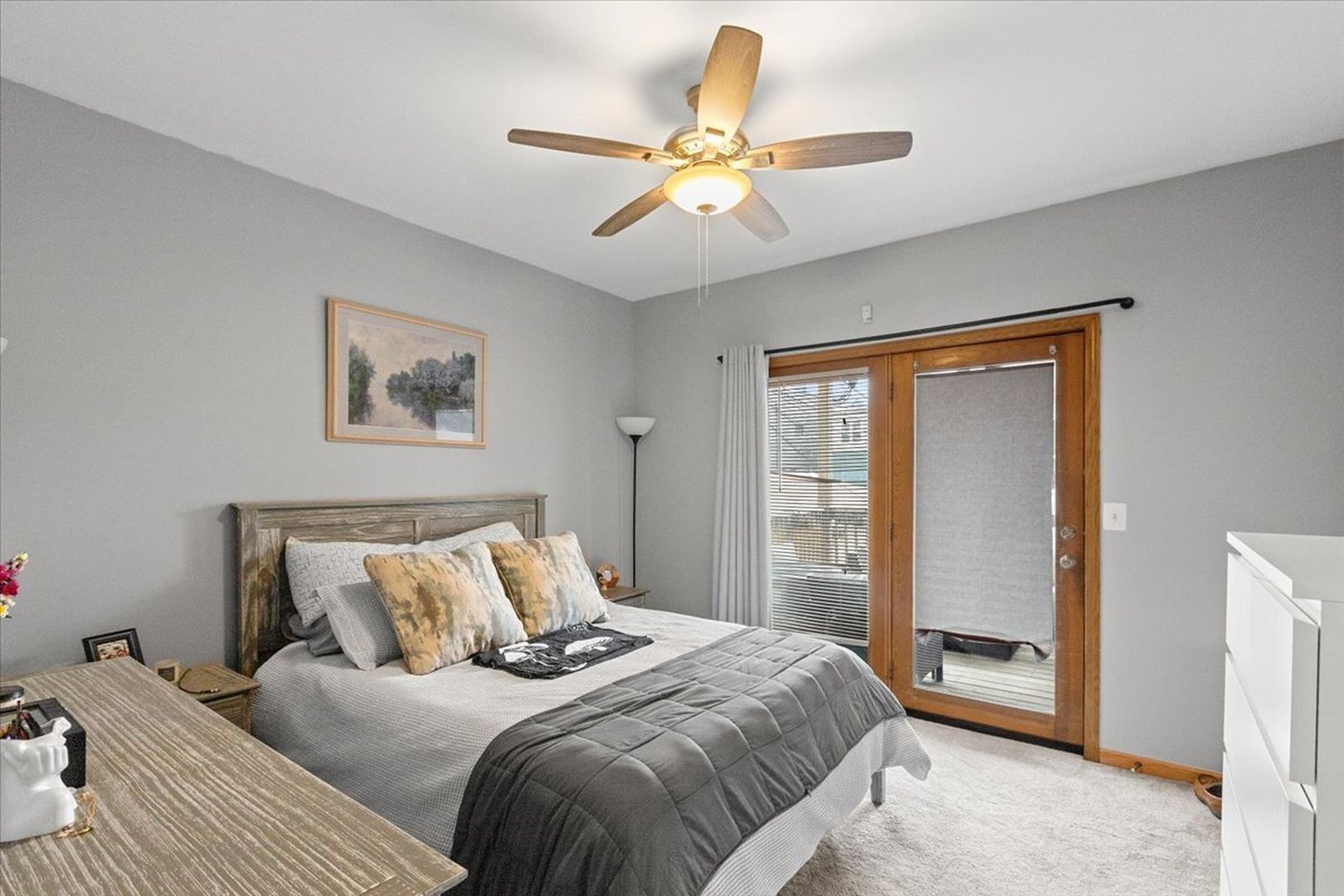 2033 West Huron Street, Unit 1 Chicago, IL 60612 - Photo 6 of 8 a bedroom with a large bed and a ceiling fan